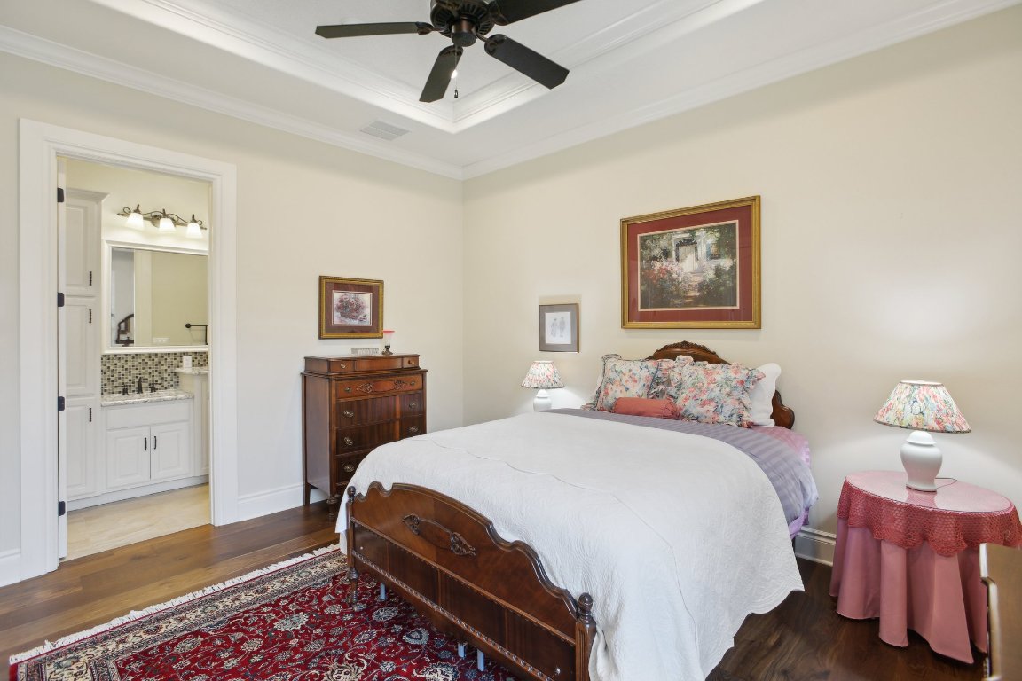 1353 Osprey Ridge Loop Lago Vista, TX 78645 - Photo 23 of 40 a bedroom with a bed and wooden floor