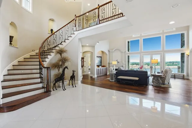 a kitchen that has a lot of white cabinets and stainless steel appliances