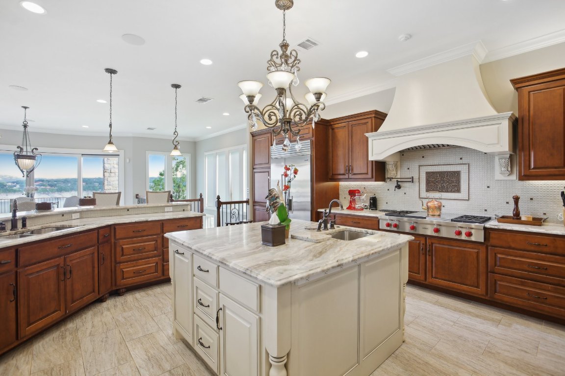 1353 Osprey Ridge Loop Lago Vista, TX 78645 - Photo 9 of 40 a kitchen with sink stove and cabinets
