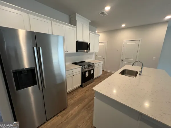 a kitchen with stainless steel appliances a refrigerator and a stove