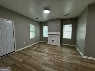a view of empty room with window and fireplace