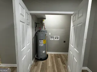 a kitchen with a sink a counter top space cabinets and stainless steel appliances