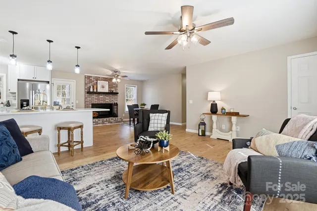 a living room with furniture and kitchen view