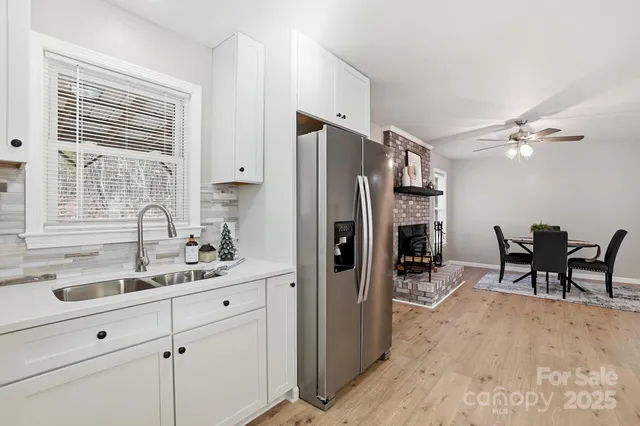 a kitchen with refrigerator cabinets and chairs