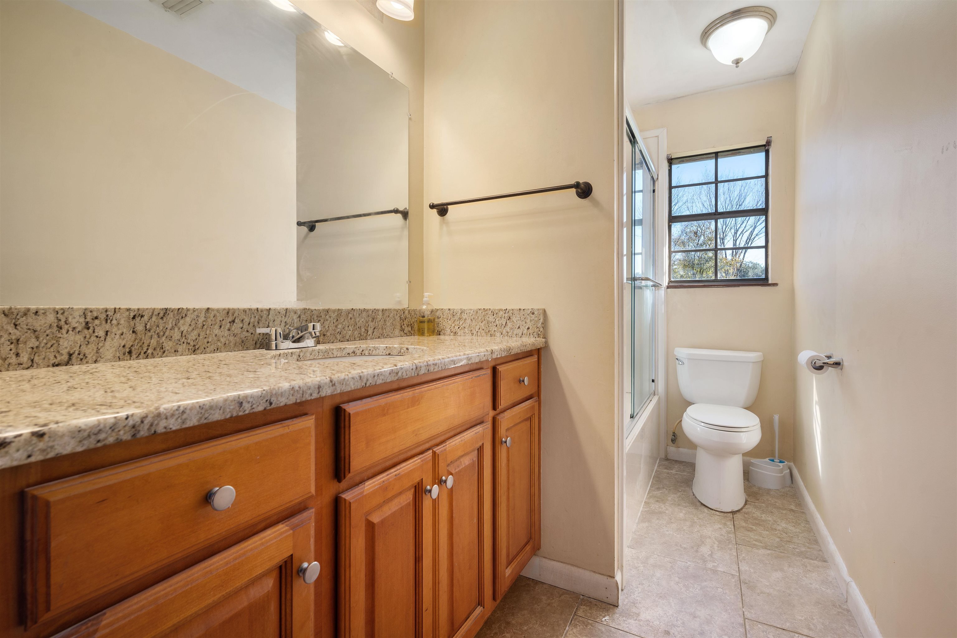 10285 Argyle Road Irvington, AL 36544 - Photo 21 of 28 Full bath with vanity, bath / shower combo with glass door, and light tile patterned floors