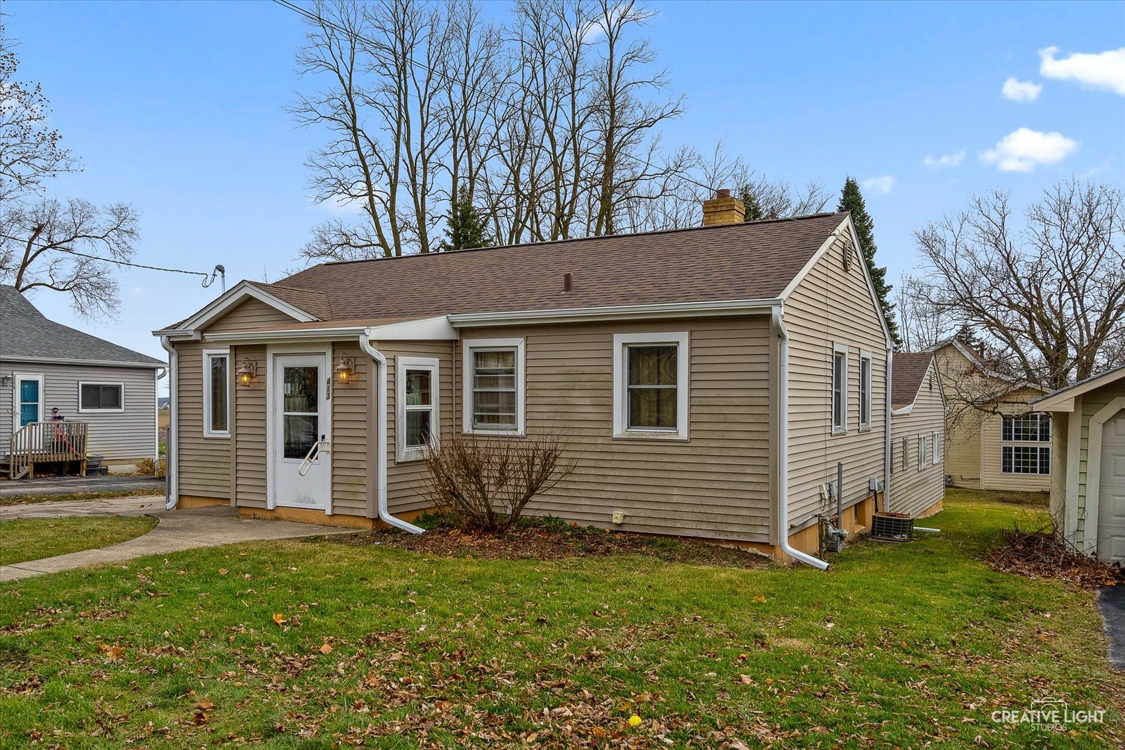 413 East Kansas Street Elburn, IL 60119 - Photo 2 of 18 a front view of a house with a garden