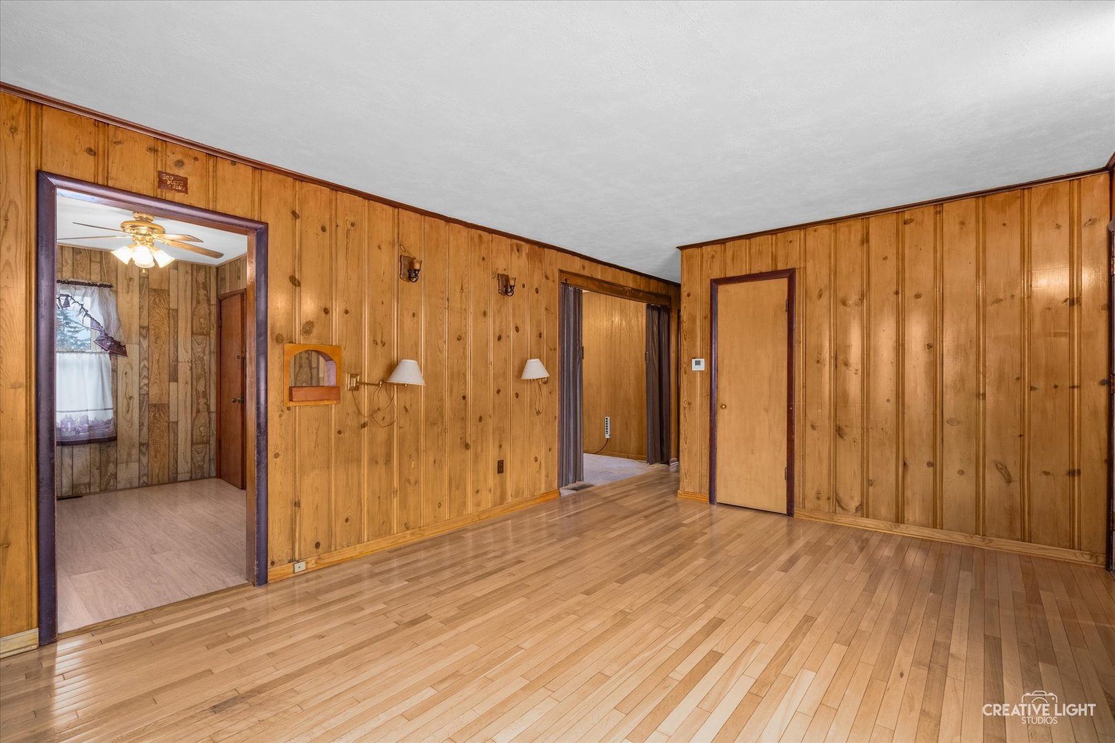 413 East Kansas Street Elburn, IL 60119 - Photo 6 of 18 a view of an empty room with wooden floor and a window