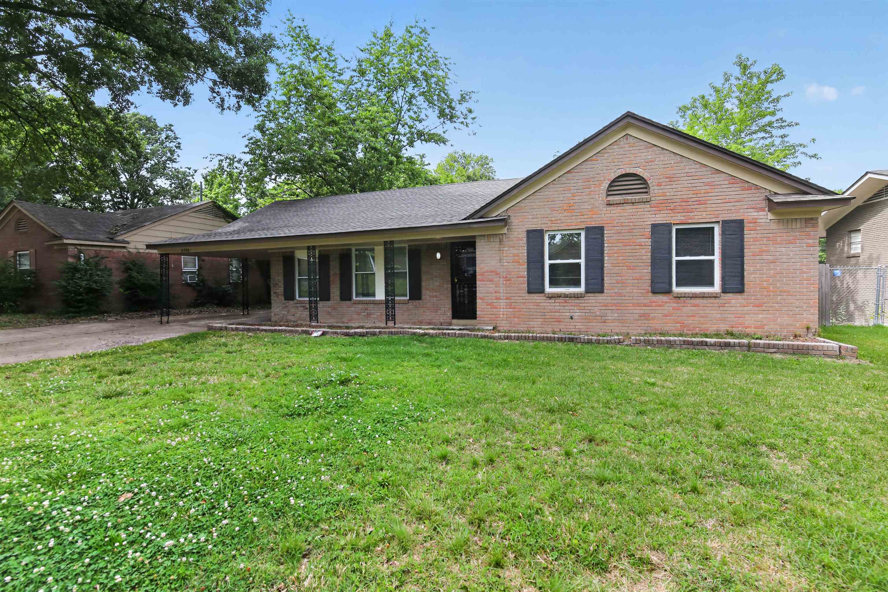 4206 Riche Road Memphis, TN 38128 - Photo 3 of 30 Brick exterior featuring a covered front porch with decorative columns, a gabled roofline, and front-facing windows with dark shutters