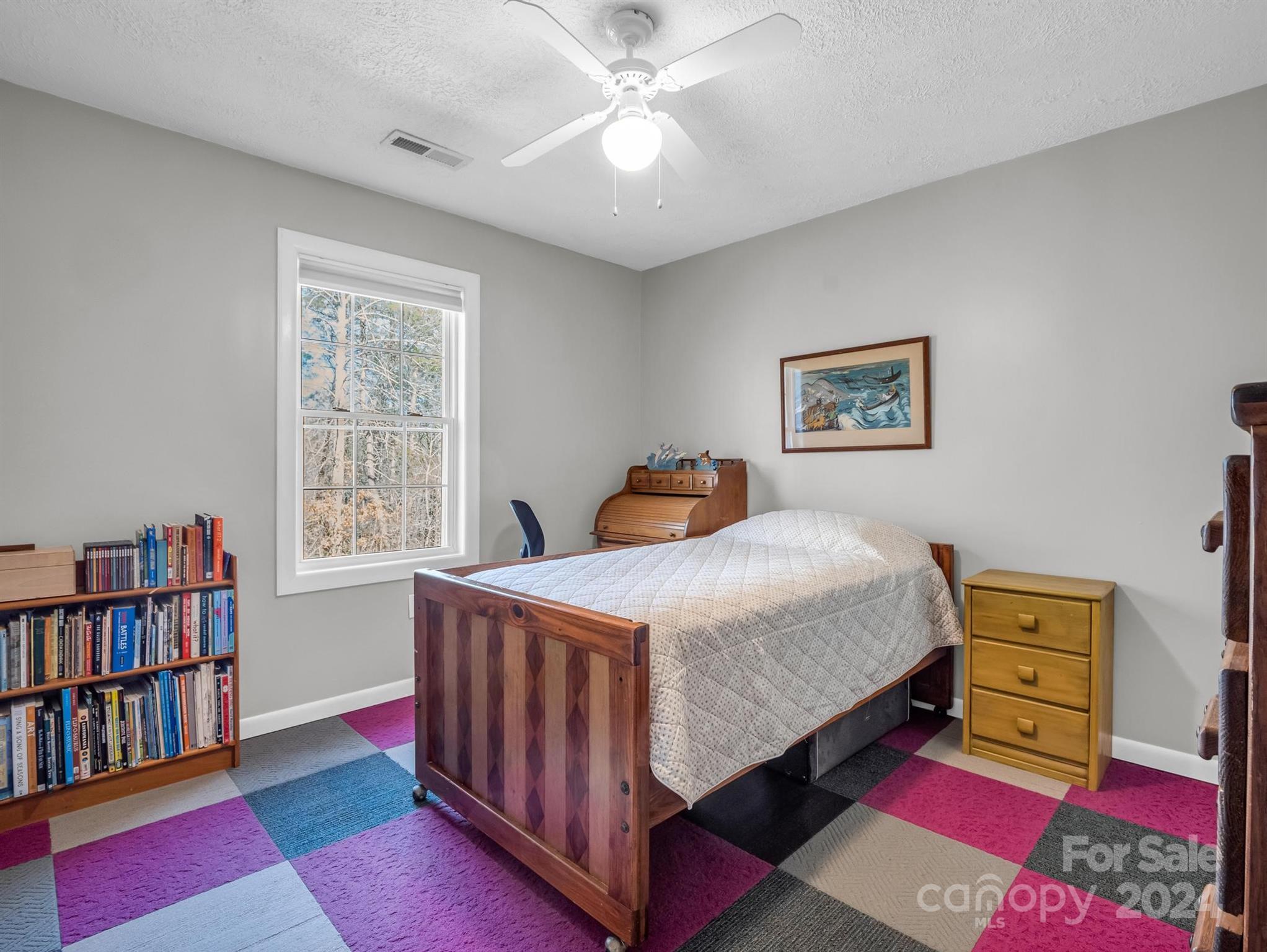284 West T Wilkins Road Rutherfordton, NC 28139 - Photo 22 of 44 a bedroom with a bed bookshelf and a window