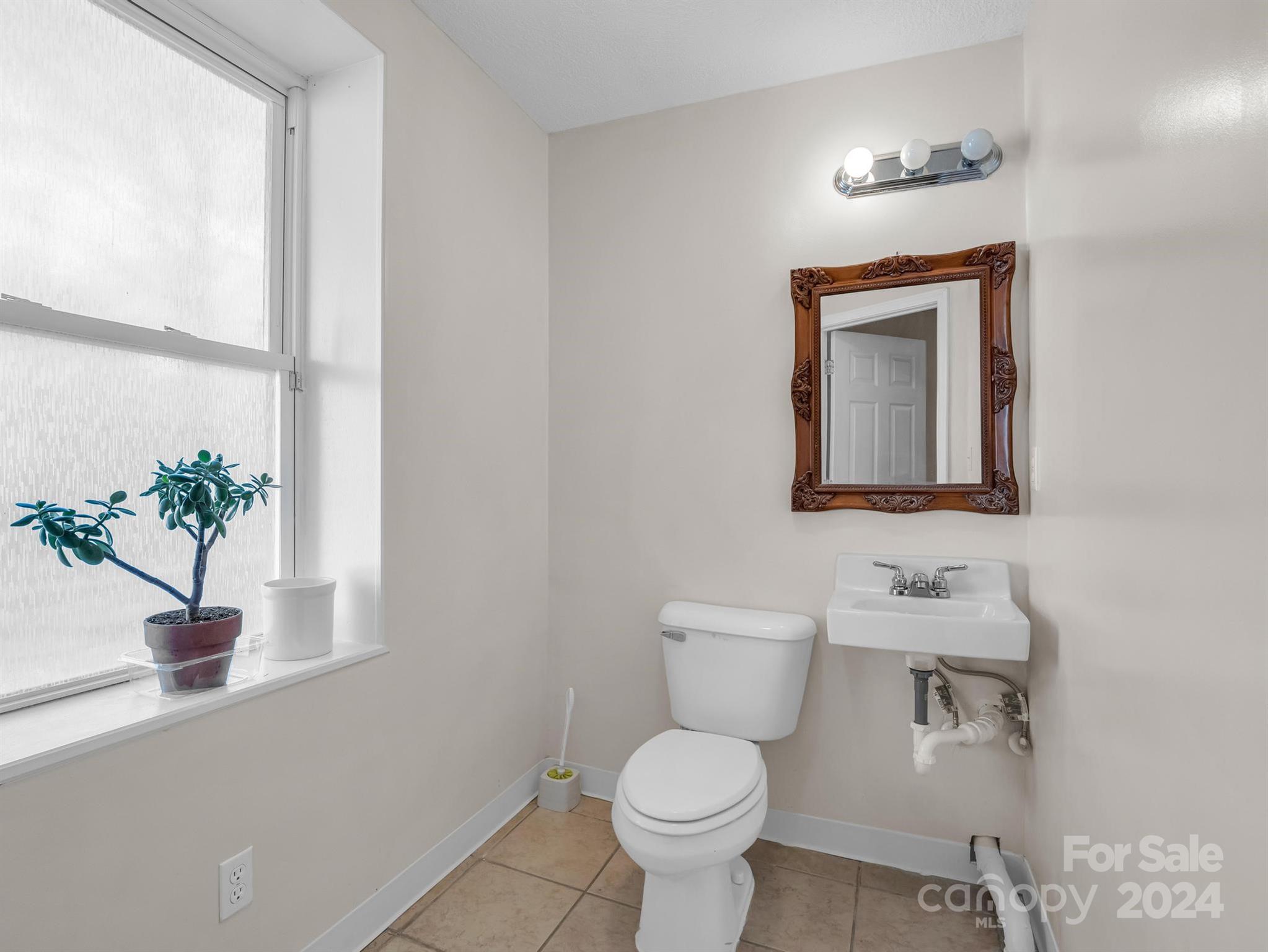 284 West T Wilkins Road Rutherfordton, NC 28139 - Photo 27 of 44 a bathroom with a toilet sink and mirror