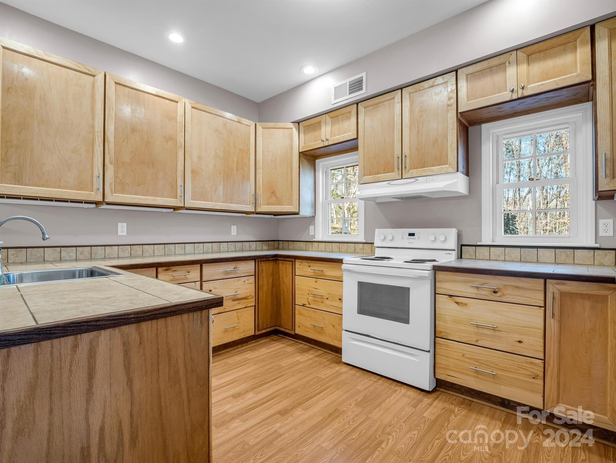 284 West T Wilkins Road Rutherfordton, NC 28139 - Photo 31 of 44 a kitchen with a stove window and cabinets