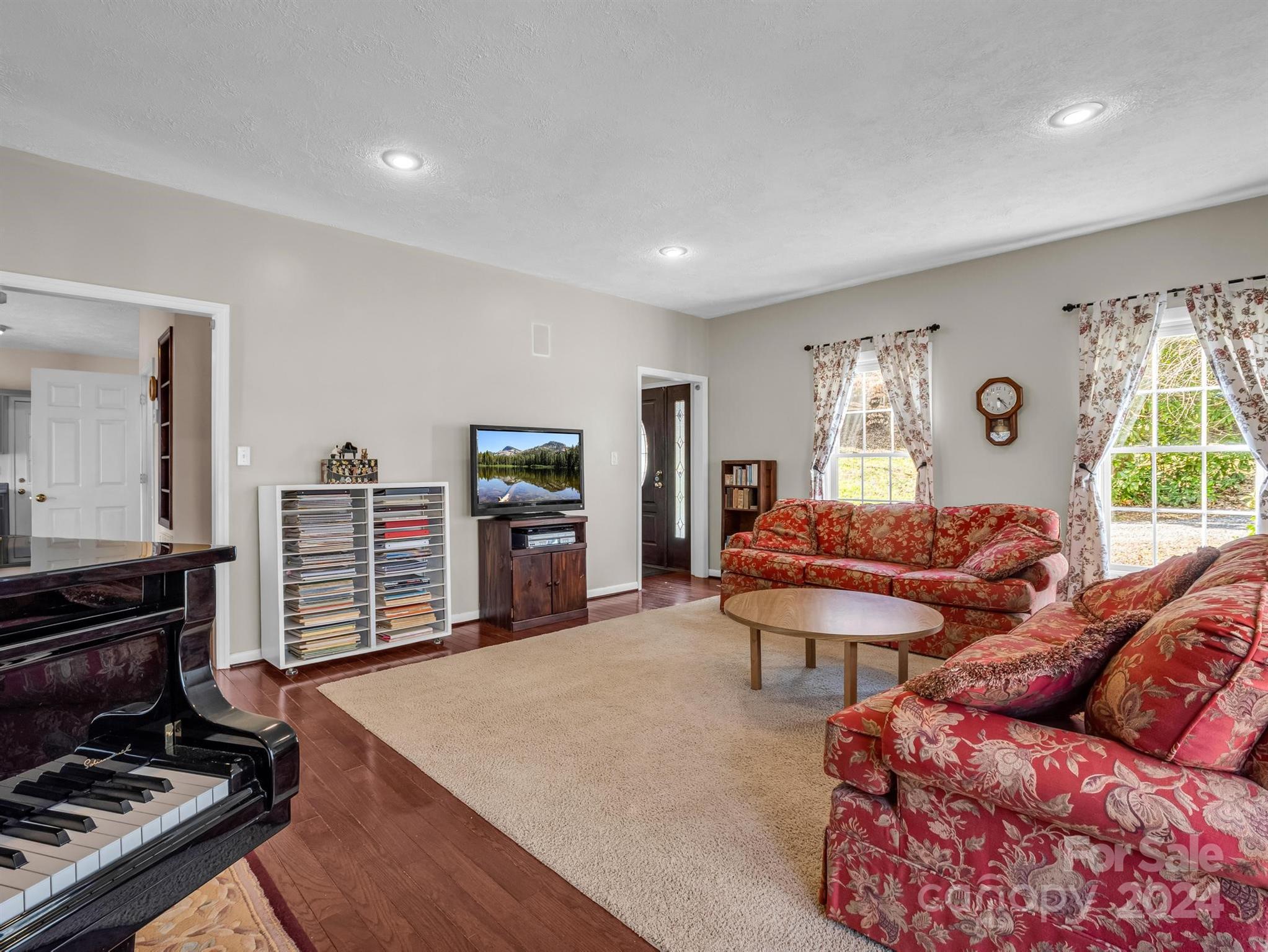 284 West T Wilkins Road Rutherfordton, NC 28139 - Photo 5 of 44 a living room with furniture a bookshelf and a stove