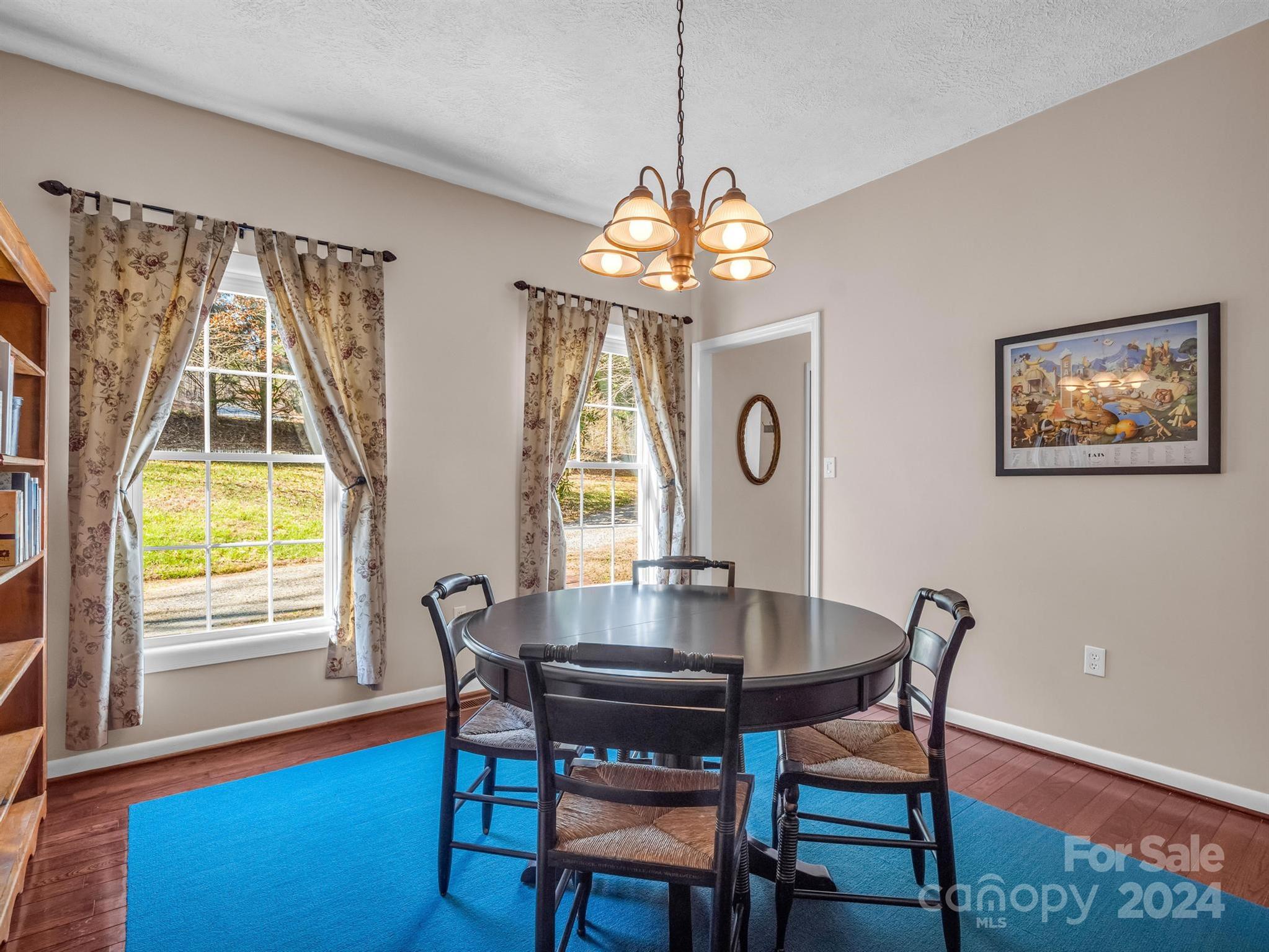 284 West T Wilkins Road Rutherfordton, NC 28139 - Photo 7 of 44 a view of a dining room with furniture a chandelier and wooden floor