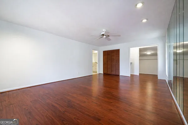 a view of an empty room with wooden floor