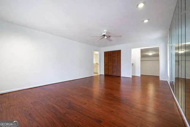 a view of an empty room with wooden floor