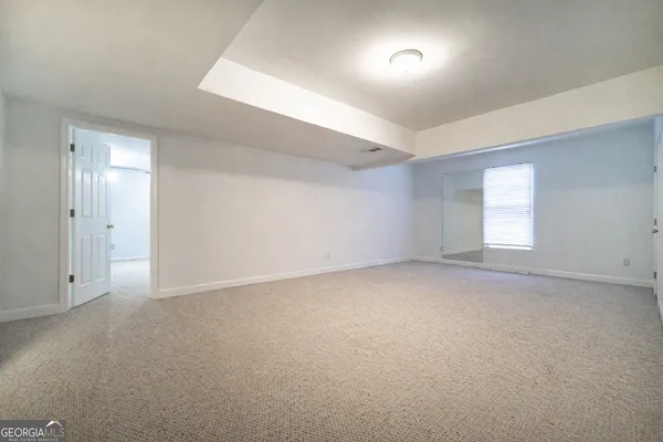 a view of an empty room and a window