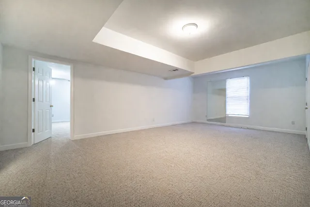 a view of an empty room and a window