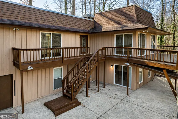 a view of a house with a wooden deck