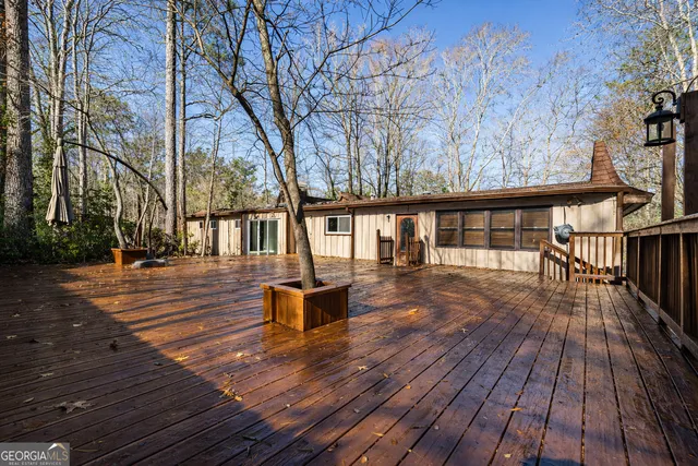 a view of backyard with deck and wooden floor
