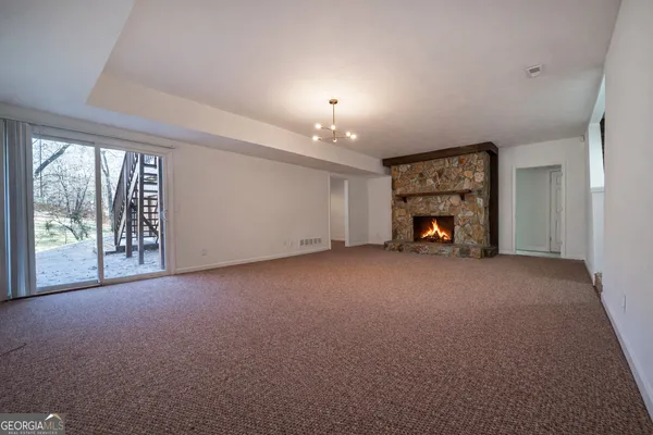 a view of a livingroom with a fireplace and a window