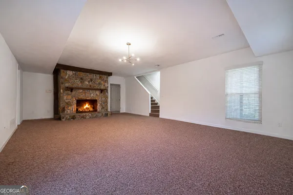 a view of empty room with a fireplace