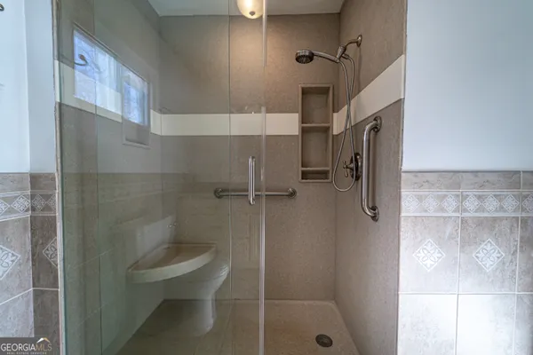 a bathroom with a shower and toilet