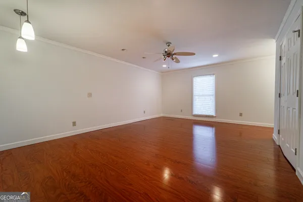 wooden floor in an empty room with a window