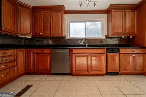 a view of a kitchen with granite countertop cabinets and window