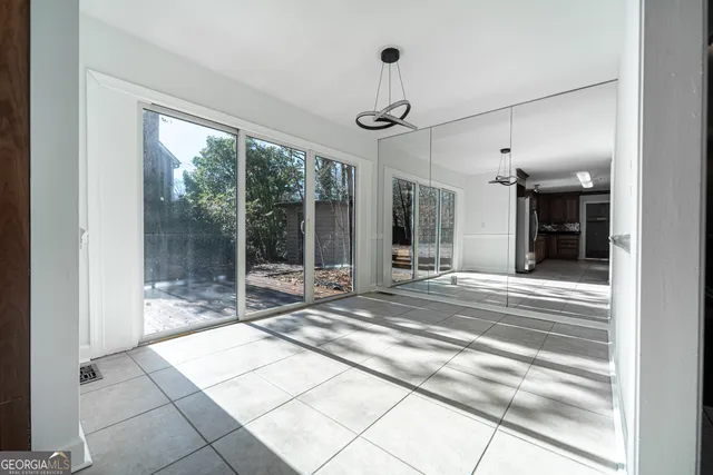 a view of lobby with a floor to ceiling window and a rug
