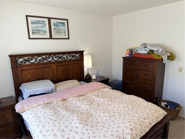 a bedroom with a bed and a dresser in it