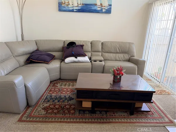 a living room with furniture and a rug