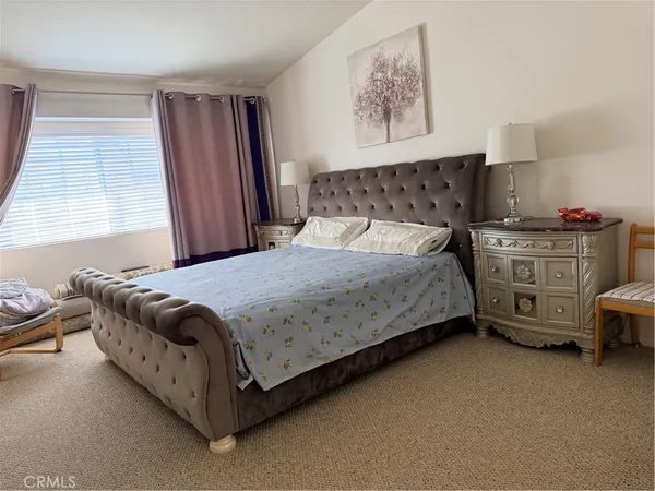 a bedroom with a bed and a couch