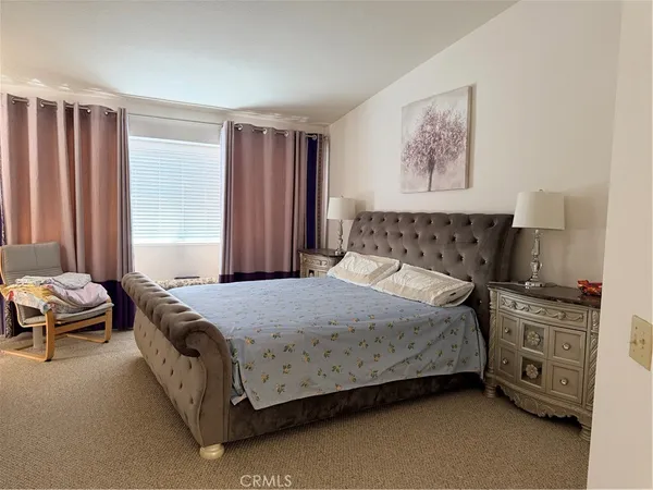 a bedroom with a bed and a couch