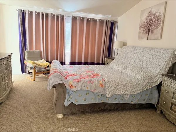 a bedroom with a bed and a furniture