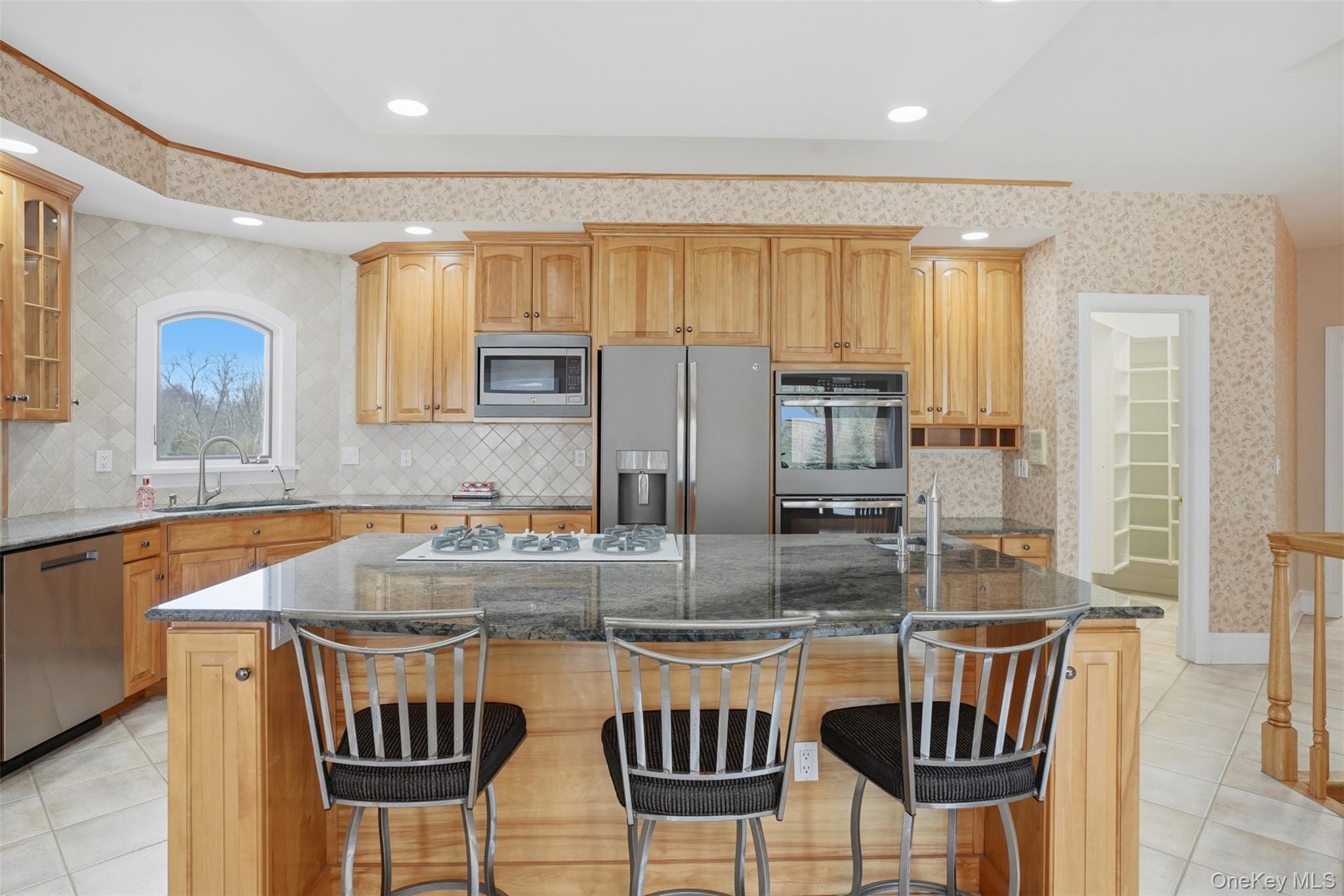 17 Forrest Way Poughkeepsie, NY 12603 - Photo 17 of 50 a kitchen with stainless steel appliances granite countertop a table chairs in it and wooden floors