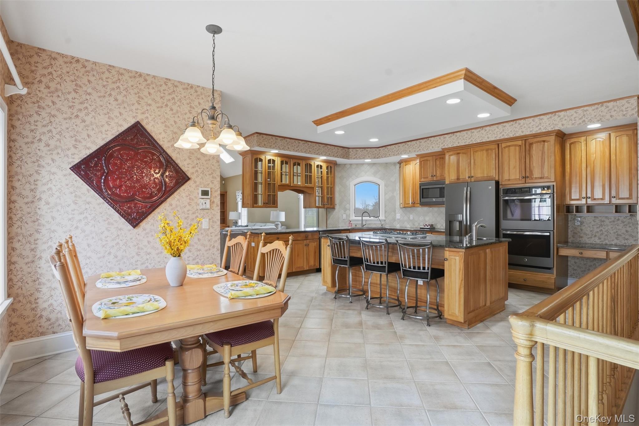 17 Forrest Way Poughkeepsie, NY 12603 - Photo 21 of 50 a dining hall with stainless steel appliances kitchen island granite countertop a table and chairs