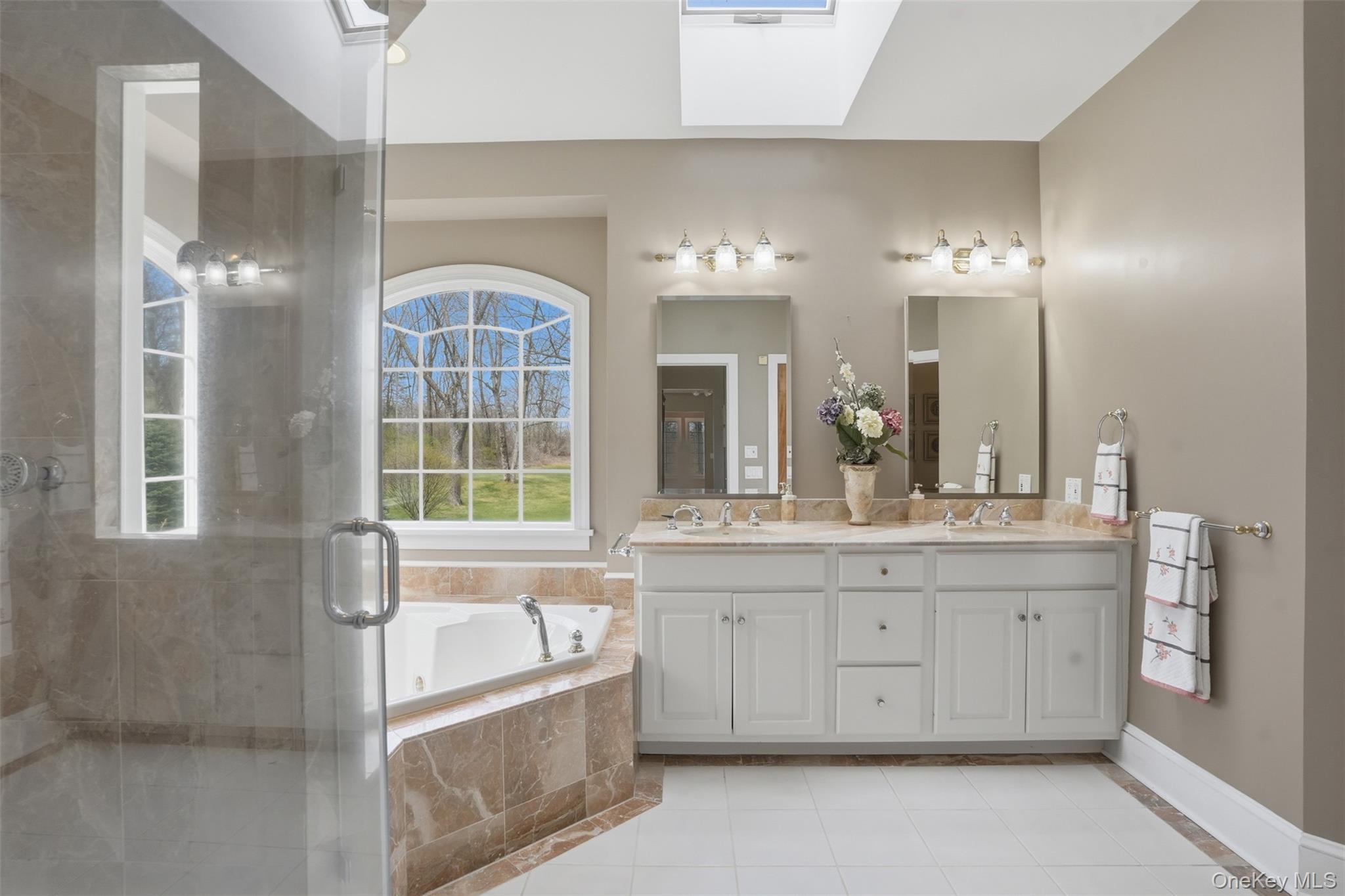 17 Forrest Way Poughkeepsie, NY 12603 - Photo 36 of 50 a bathroom with a granite countertop tub a sink and a large mirror