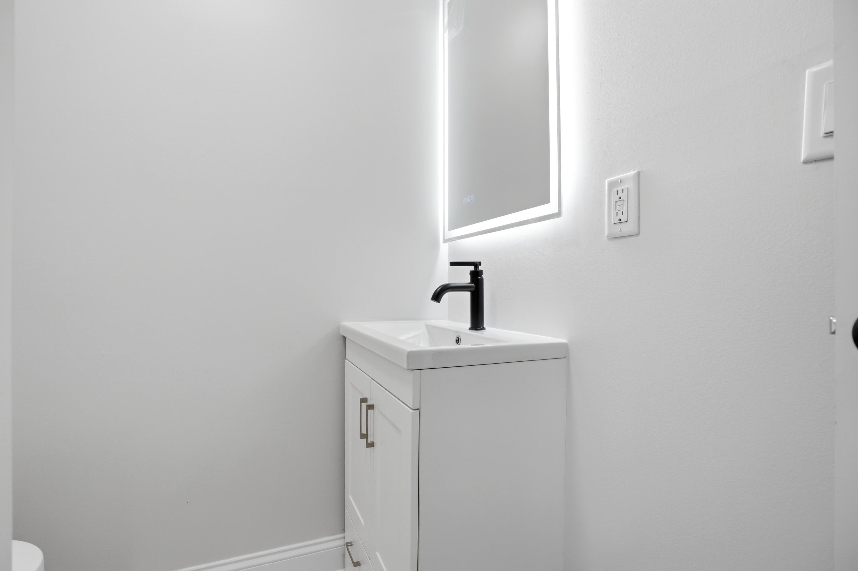 1960 Chase Street Gary, IN 46404 - Photo 42 of 45 a bathroom with a sink and mirror