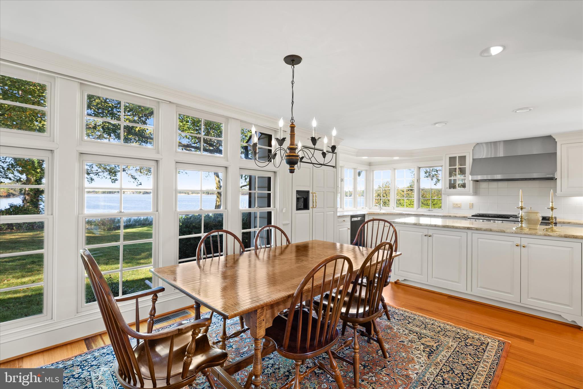 27473 Westpoint Road Easton, MD 21601 - Photo 15 of 58 a dining room with furniture a chandelier and wooden floor