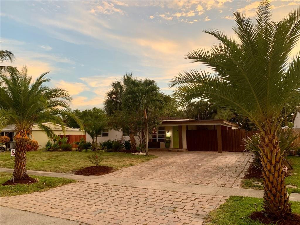 1101 Southwest 1st Avenue Pompano Beach, FL 33060 - Photo 1 of 30 a front view of a house with a yard and trees