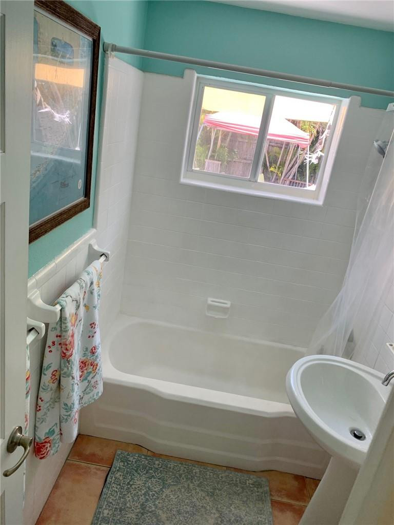 1101 Southwest 1st Avenue Pompano Beach, FL 33060 - Photo 23 of 30 a bathroom with a tub and a shower