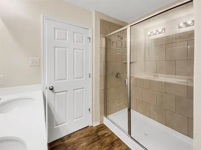 a bathroom with a glass shower door