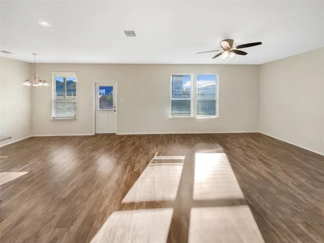 a view of wooden floor and windows in a room