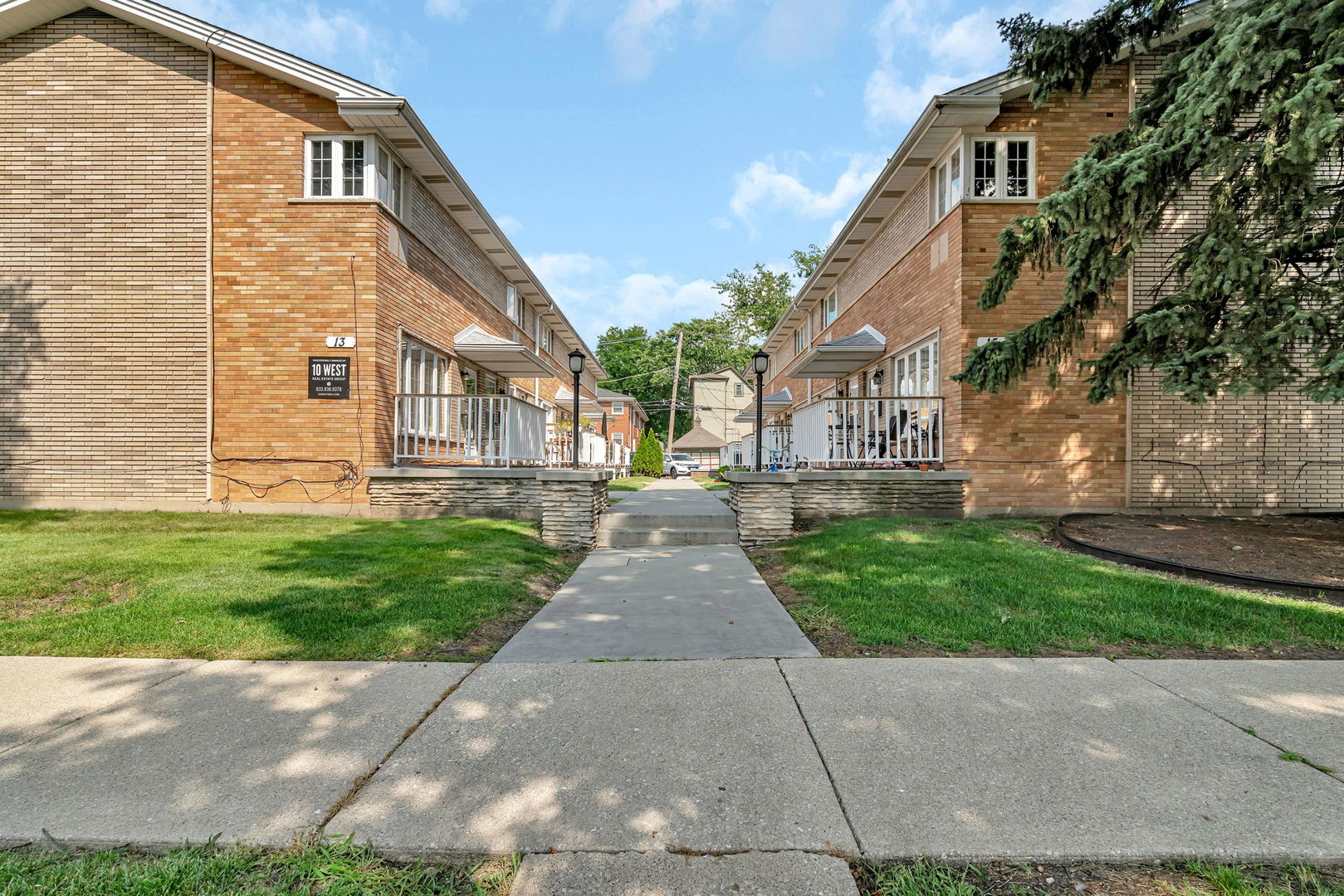 13 South Waiola Avenue, Unit 5 La Grange, IL 60525 - Photo 3 of 22 a view of a white house next to a yard and large trees