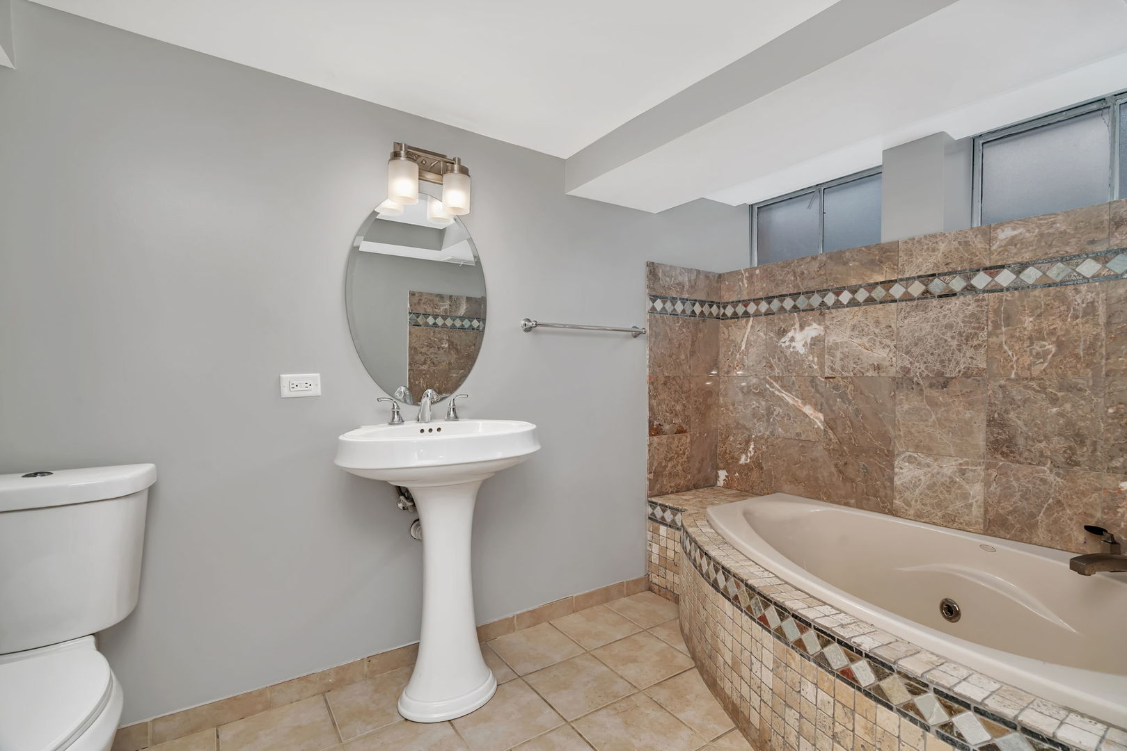13 South Waiola Avenue, Unit 5 La Grange, IL 60525 - Photo 10 of 22 a bathroom with a sink a toilet and bathtub
