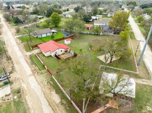 an aerial view of a houses with yard