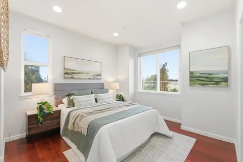 a bedroom with a bed and a painting on the wall