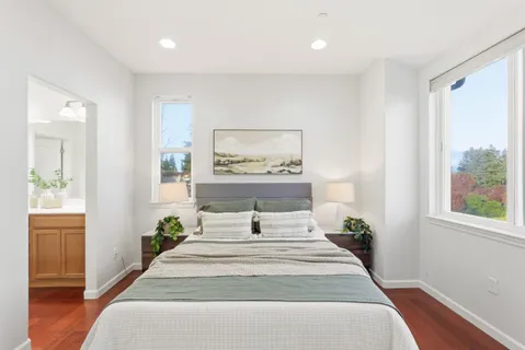a bedroom with a bed and painting on the wall