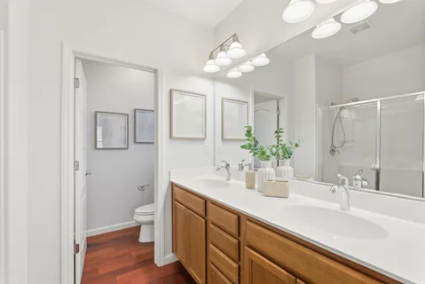 a bathroom with a sink a mirror and a shower