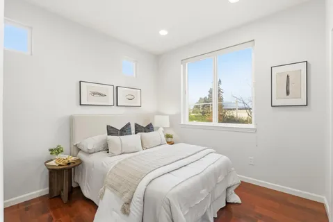 a bedroom with a bed and a mirror